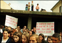 From a rooftop perch, Albanian youngsters watch a parade of older students on the first day of the new school year. The students were unable to study in the Serb-controlled schools. - All images copyright Lisa Nipp 2010