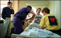 Marcia lets out a yelp as RNs Roy Alsobrook and Kim Schafer draw blood for the fourth time on the morning of the transplant surgery. Meanwhile, Bob alerts friends from First Baptist Church "to crank up the prayers" in preparation for the surgery. - All images copyright Lisa Nipp 2010