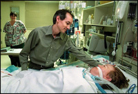 Bob greets a just awakened Marcia while RN Dorothy Nuusilla hovers close-by in the Surgical Intensive Care Unit. Surgeons closed her chest cavity in the morning but left her on the ventilator while her condition continues to stabilize. - All images copyright Lisa Nipp 2010