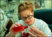 Weak and shaky, Marcia struggles to measure a correct dosage of one of the 24 medications she must take daily to ward off infection and prevent organ rejection. - All images copyright Lisa Nipp 2010