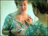 Marcia covers her scar with zinc oxide--a trick used by models--and later with make-up so that it will not show. The faint scar runs from the base of her neck to three inches above her navel. - All images copyright Lisa Nipp 2010